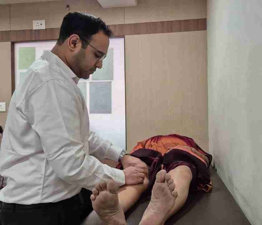 Dr. Pranav Charde examining a patient during a clinical consultation